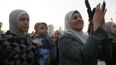 EPA People celebrate the overthrow of Syrian President al-Assad, at the Umayyad Square in Damascus,