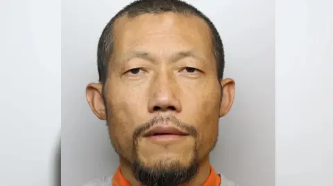 Wiltshire Police Hongchi Xiao looking into the camera in a police mugshot