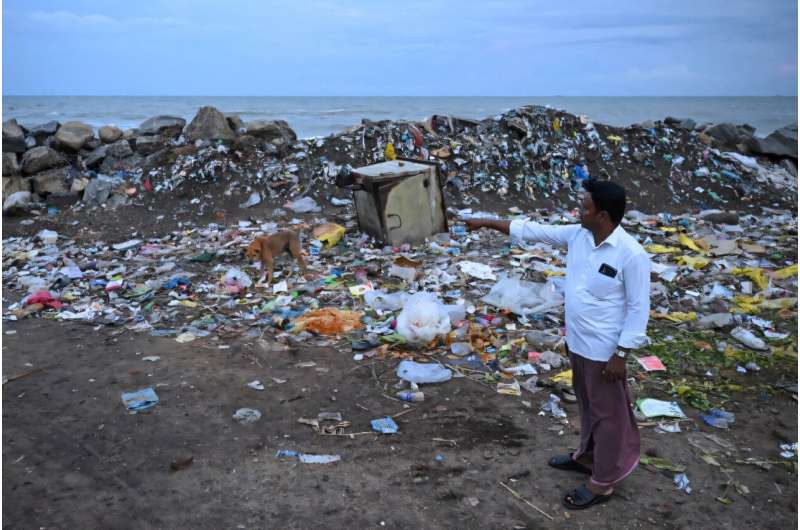 P. Mohan, a fisherman and 2004 tsunami victim, shows the former location of his house, which was swept away in the disaster