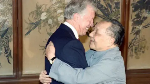 Getty Images Former US Presidents Jimmy Carter (L) and China's paramount leader Deng Xiaoping hug each other on June 29, 1987 in Beijing.