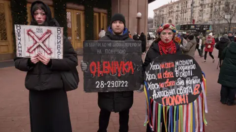 BBC People are seen protesting for the return of prisoners of war