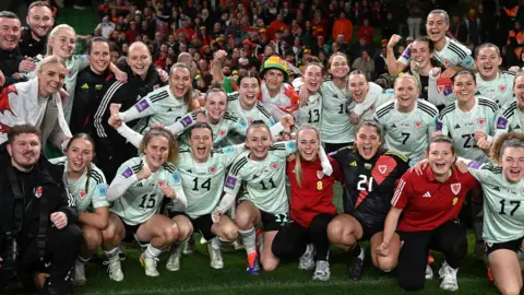 Getty Images Players of Wales pose for team a photo following victory in the UEFA Women's EURO 2025. 