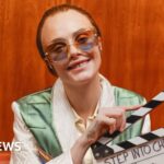 Cara Delevingne plays Elton John in Step Into Christmas video remake