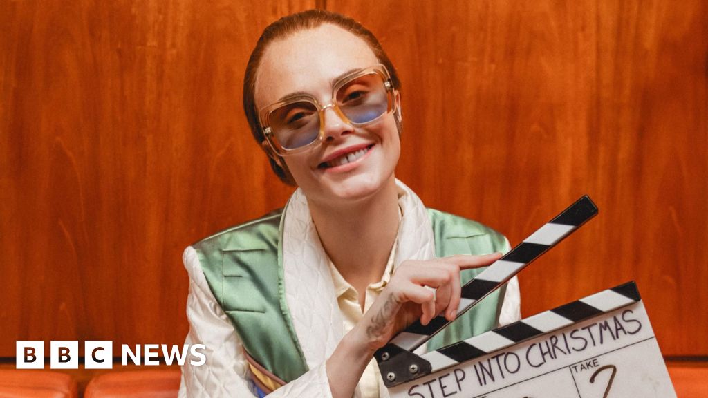 Cara Delevingne plays Elton John in Step Into Christmas video remake