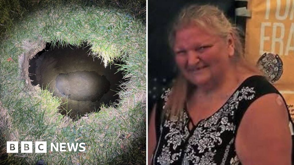 Search under way for woman believed trapped in sinkhole