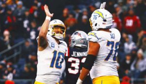 Chargers clinch playoff spot in Jim Harbaugh’s 1st season with 40-7 rout of Patriots