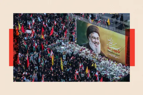 Getty Images Iranians lay flowers beneath a billboard bearing a portrait of Hassan Nasrallah