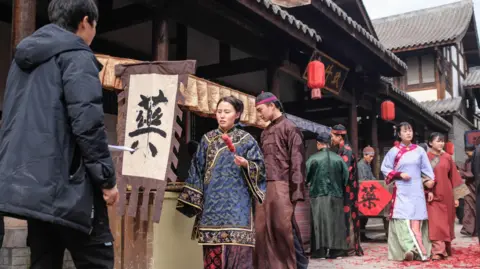 Getty Images Many young graduates travel to Hengdian to work as movie extras in the studios' productions