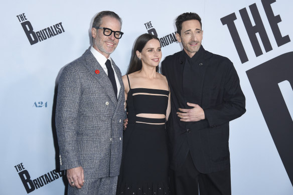 Guy Pearce, Felicity Jones and Adrien Brody arrive at the premiere of The Brutalist last month.