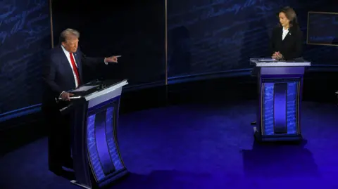 Reuters President Donald Trump points towards Democratic presidential nominee,  Vice President Kamala Harris, as he speaks during a presidential debate 