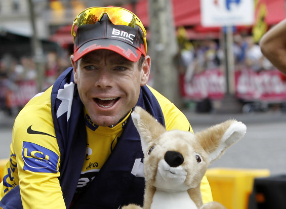 Cadel Evans cycles down the Champs Elysees in Paris after winning the Tour de France in 2011. 