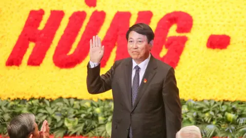 Shutterstock Vietnam President Luong Cuong wears a suit and waves his hand