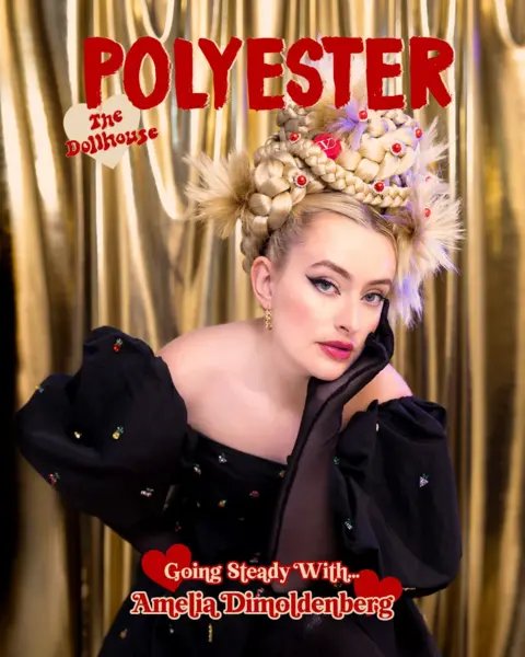 Megan Winstone Amelia Dimoldenberg on the cover of Polyester magazine. Her blonde hair is plaited nigh on her head and she is wearing a black shoulderless dress.