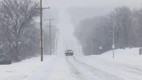 Getty Images Snow covered road in Kansas. 