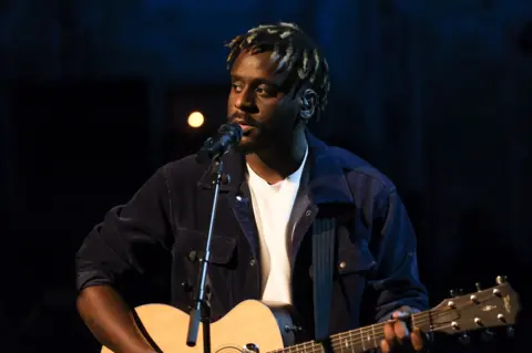 Myles Smith plays guitar and sings during a taping of the TV show Later... With Jools Holland