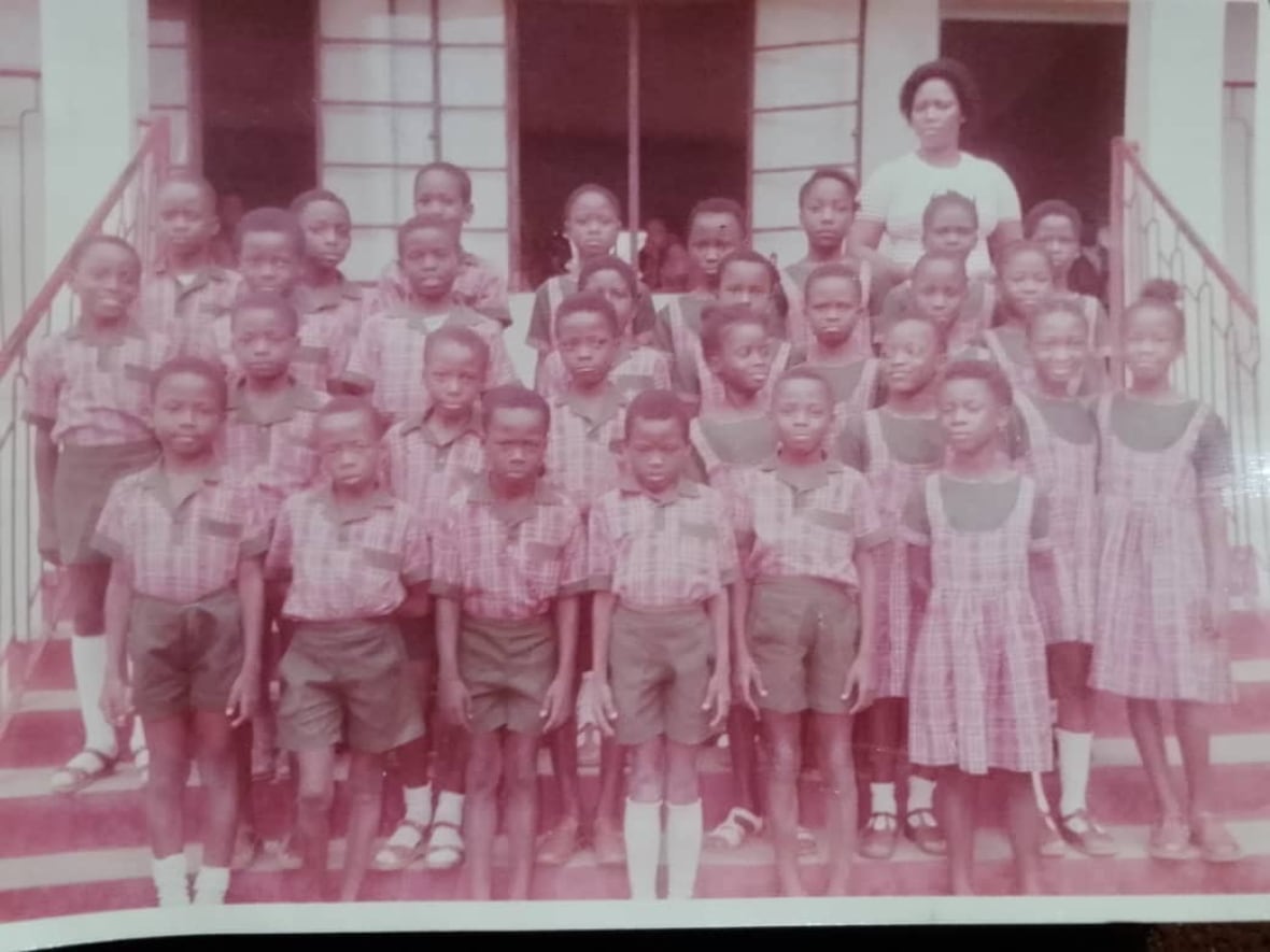 A class of children in a dated photo pose for a class picture. 