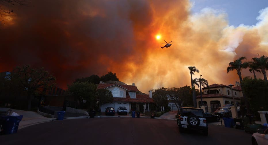 TOPSHOT - Plumes of smoke are seen as a brush fire burns in Pacific Palisades, California on January 7, 2025. A fast-moving brushfire in a Los Angeles suburb burned buildings and sparked evacuations Tuesday as "life threatening" winds whipped the region. More than 200 acres (80 hectares) was burning in Pacific Palisades, a upscale spot with multi-million dollar homes in the Santa Monica Mountains, shuttering a key highway and blanketing the area with thick smoke. (Photo by David Swanson / AFP) (Photo by DAVID SWANSON/AFP via Getty Images)