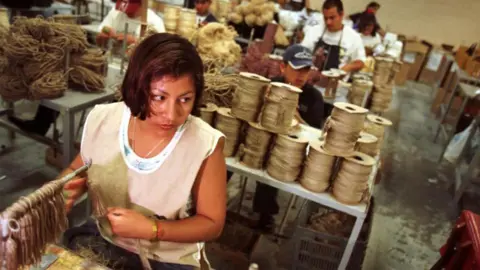 Getty Images Workers at a factory in Mexico that makes home furnishings