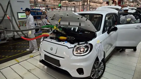 Getty Images Electric vehicles being assembled at a factory in China