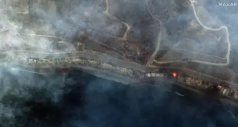 Reuters A satellite image shows smoke covering the Pacific Coast Highway along the Malibu coastline due to the devastating wildfires.