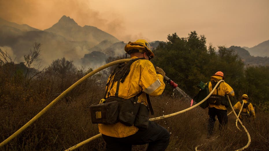 MALIBU, CA - NOVEMBER 10: Los Angeles County firefighters attack flames approaching the Salvation Army camps in Malibu Creek State Park during the Woolsey Fire on November 10, 2018 near Malibu, California. The Woolsey fire has burned over 70,000 acres and has reached the Pacific Coast at Malibu as it continues grow. (Photo by David McNew/Getty Images)