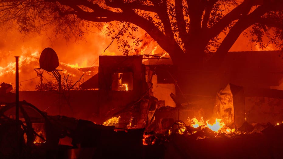 PASADENA, CALIFORNIA - JANUARY 7: Homes burn as powerful winds drive the Eaton Fire on January 7, 2025 in Pasadena, California. A powerful Santa Ana wind event has dramatically raised the danger of wind-driven wildfires such as the dangerous and destructive Palisades Fire near Santa Monica. The strong winds also forced President Joe Biden to cancel his plan to travel between Los Angeles and Riverside, California. (Photo by David McNew/Getty Images)