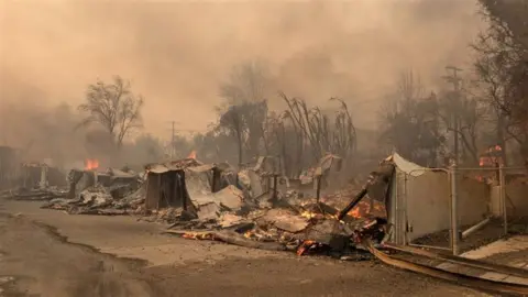 Lucy Sherriff / BBC Burned out remains of homes on Lucy's street