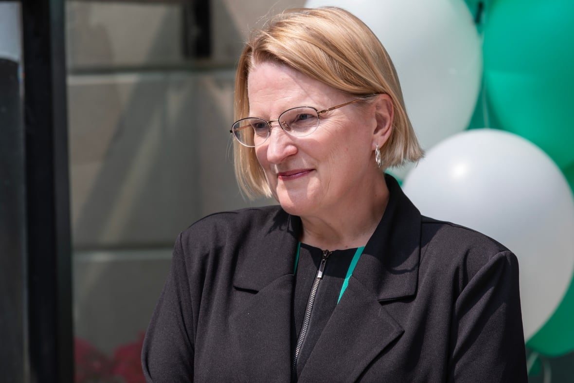 A politician at an announcement outside in late spring.