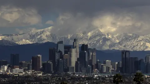 Shutterstock The San Bernardino Mountains covered in snow above downtown Los Angeles under a menacing sky