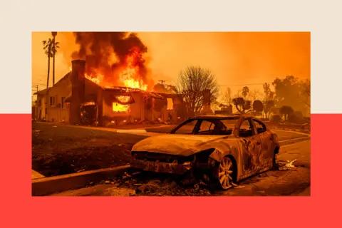 Getty Images A burnt-out car in front of a house on fire