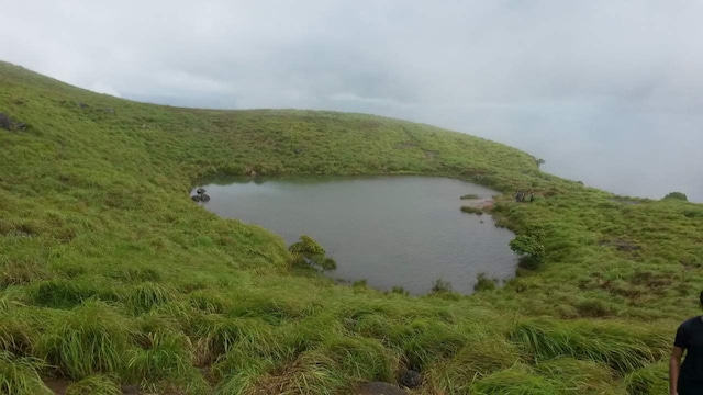 Chembra Peak, Wayanad, Kerala | Chembra Peak, the highest peak in Wayanad, offers stunning views and a challenging trek. The heart-shaped lake is surrounded by waterfalls, tea plantations, hills and lush green valleys. The best season for trekking is during the winter. From the top of the peak, you can see the complete range of Wayanad.