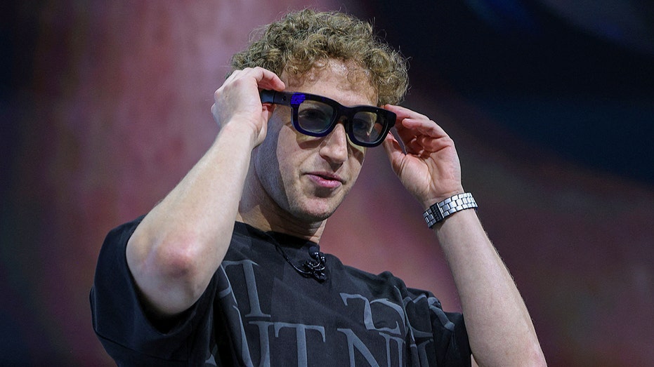 Mark Zuckerberg putting on glasses