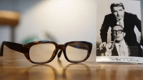 PA Media Eric Morecambe's distinctive glasses