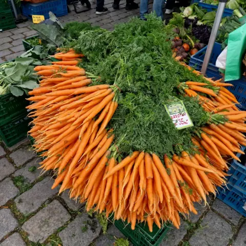 Zuzana Hájková A pile of carrots on sale at a market