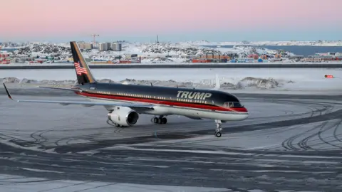 Reuters A plane with the words 'Trump' on the side at an airport in Greenland with snow and ice on the tarmac