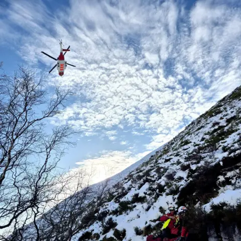 Edale MRT A hovering helicopter viewed from below on an icy slope