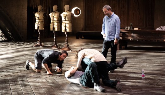 Fraser (crouching) on the set of Dune as director Denis Villeneuve looks on.