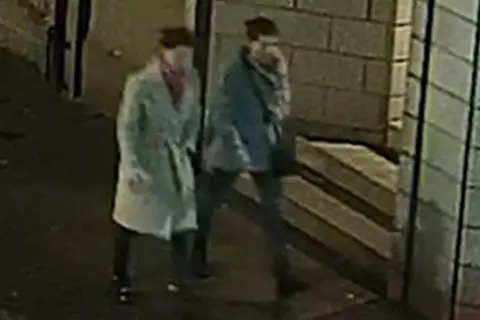 Police Scotland Colour CCTV image of two missing sisters - Eliza and Henrietta Huszti - walking in an Aberdeen street, both wearing what appear to be warm grey jackets