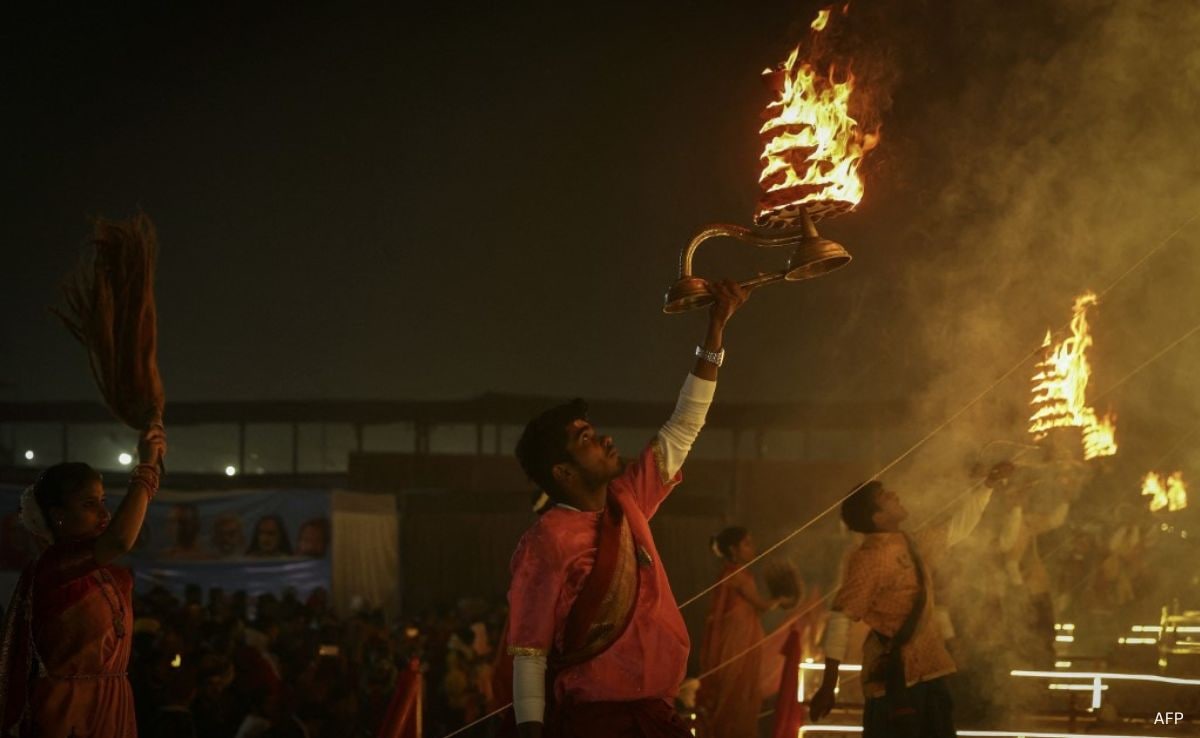 A priest performs evening prayers ahead of the Maha Kumbh in Prayagraj