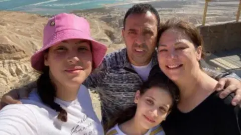 FAMILY PHOTO Eli Sharabi, pictured with his family, has been missing since he was captured 11 months ago