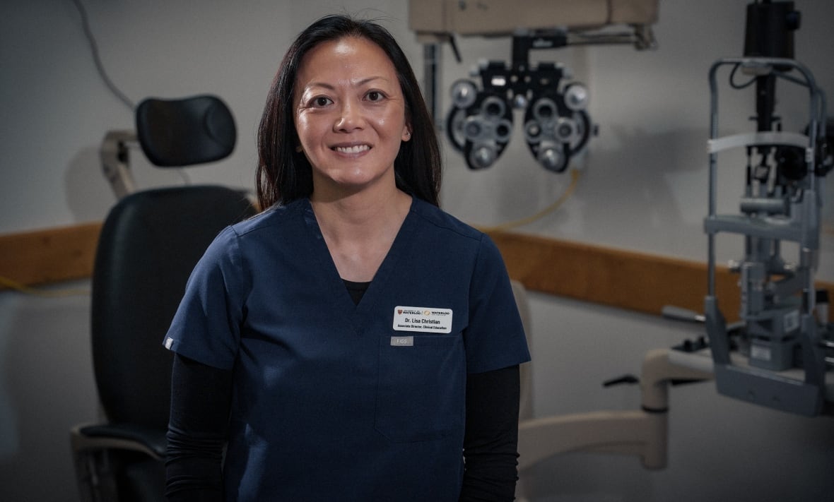 Photo of Lisa Christian standing in an eye exam room. 