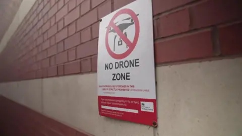 BBC A "No Drones Zone" sign at Manchester prison. 