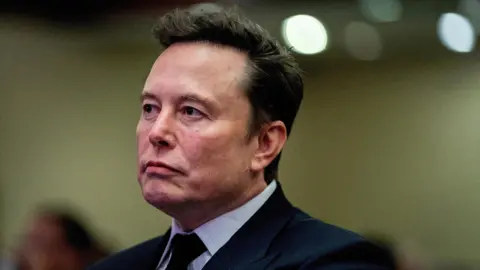 Reuters A close-up shot of Tesla CEO and X owner Elon Musk listening as US President-elect Donald Trump speaks to a meeting of House of Representatives Republicans