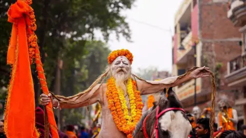 Getty Images A Sadhu, or Hindu holy man, rides a horse during a religious procession of the Mahanirvani Akhada, ahead of the Maha Kumbh Mela festival in Prayagraj on January 2, 2025. (Photo by HIMANSHU SHARMA / AFP) (Photo by HIMANSHU SHARMA/AFP via Getty Images)