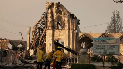 Reuters Firefighters work near a church destroyed in the Palisades Fire, in the Pacific Palisades neighborhood in Los Angeles, California, U.S. January 10, 2025.