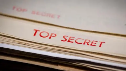 PA Media A file is shown with the words 'Top secret' in red letters across the top.