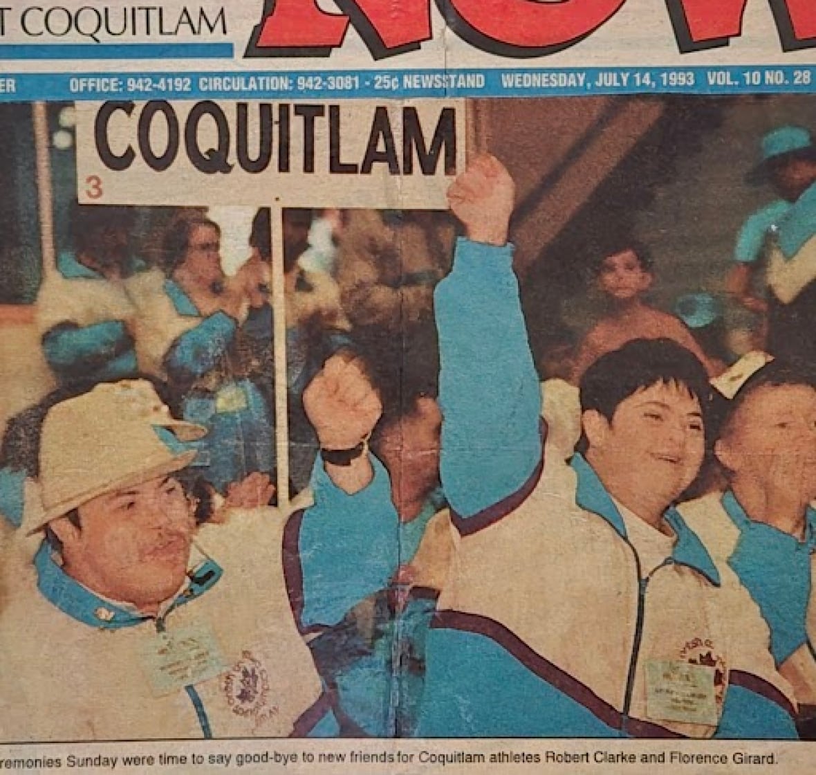 A coloured photo shows a woman with Downs syndrome dressed in a blue and white uniform with her fist raised in the air in jubilation. A man beside her dressed similarly holds a sign that says Coquitlam.