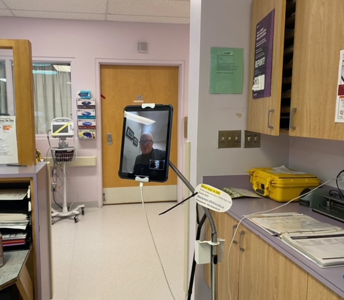 A man is on a tablet screen inside a hospital. 