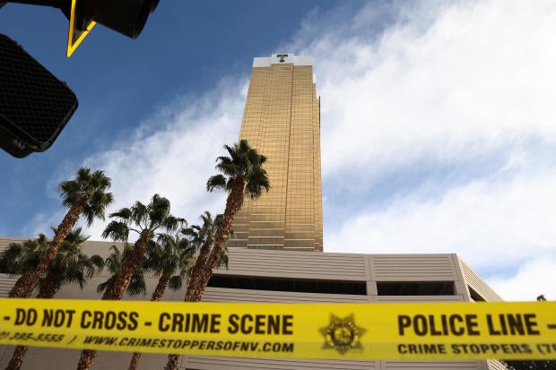 Firefighters work at the Tesla Cybertruck which burned at the entrance of Trump Tower in Las Vegas 