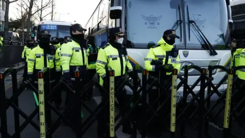 EPA Police officers gather near the Corruption Investigation Office for High-ranking Officials as people await the arrival of impeached South Korean President Yoon Suk Yeol